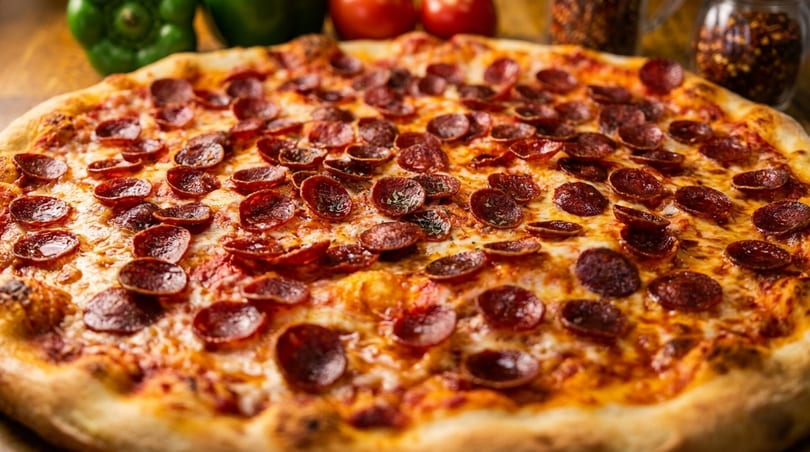 Close-up of a freshly baked pepperoni pizza with melted cheese and a golden crust.